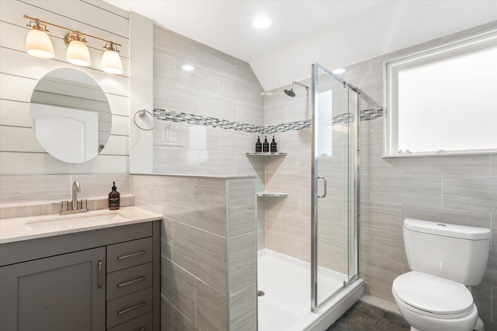 1 2nd Lane St. Augustine, FL 32080 - Photo 50 of 86 Full bathroom featuring tile walls, vanity, and a shower stall