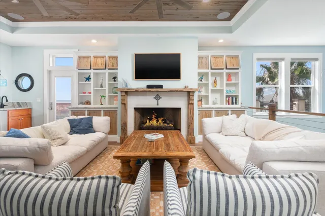 a dining room with furniture a chandelier and wooden floor