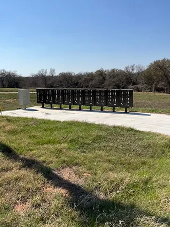 a view of a swimming pool with a yard and plants