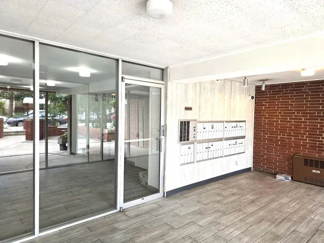 a view of kitchen with furniture and refrigerator