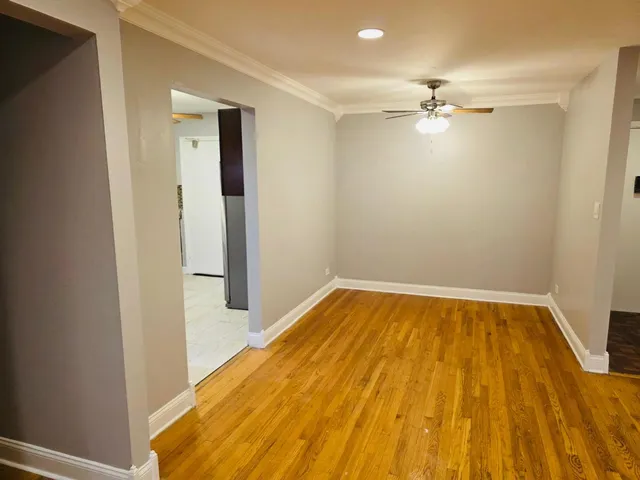a view of a room with wooden floor and staircase