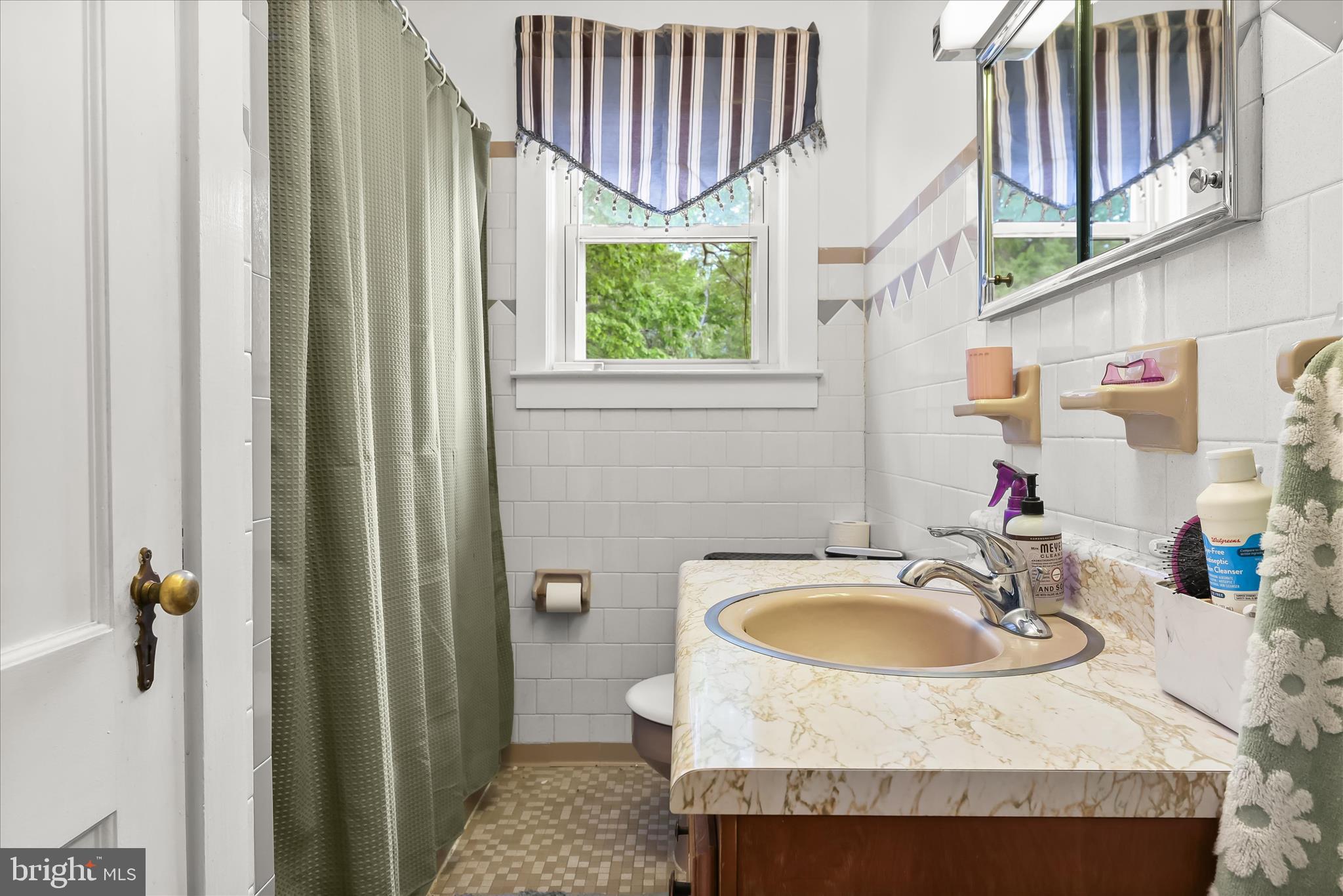 3703 Clayton Road Joppa, MD 21085 - Photo 20 of 31 a bathroom with a sink and a mirror