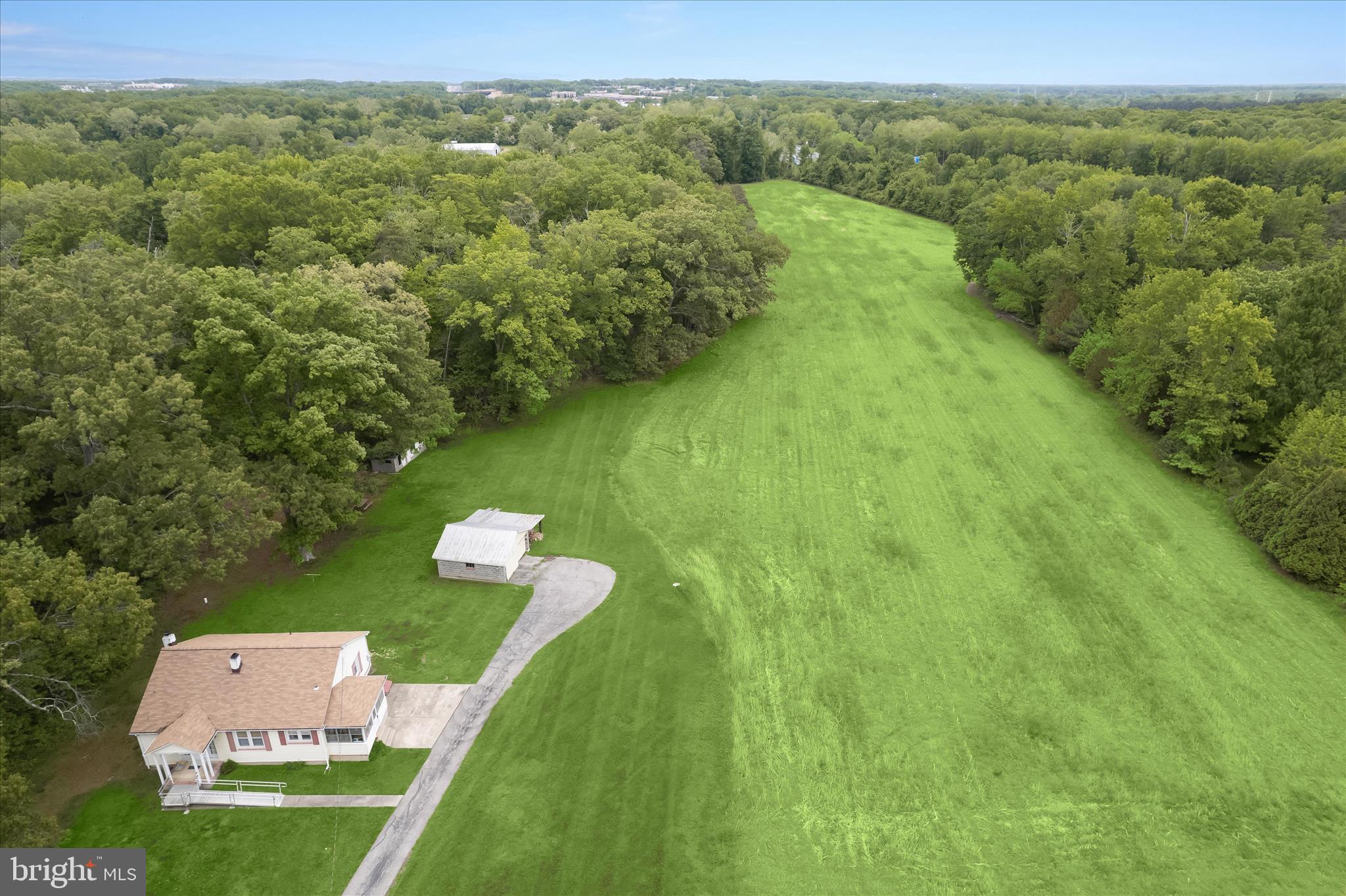 3703 Clayton Road Joppa, MD 21085 - Photo 5 of 31 a view of a city and lush green forest