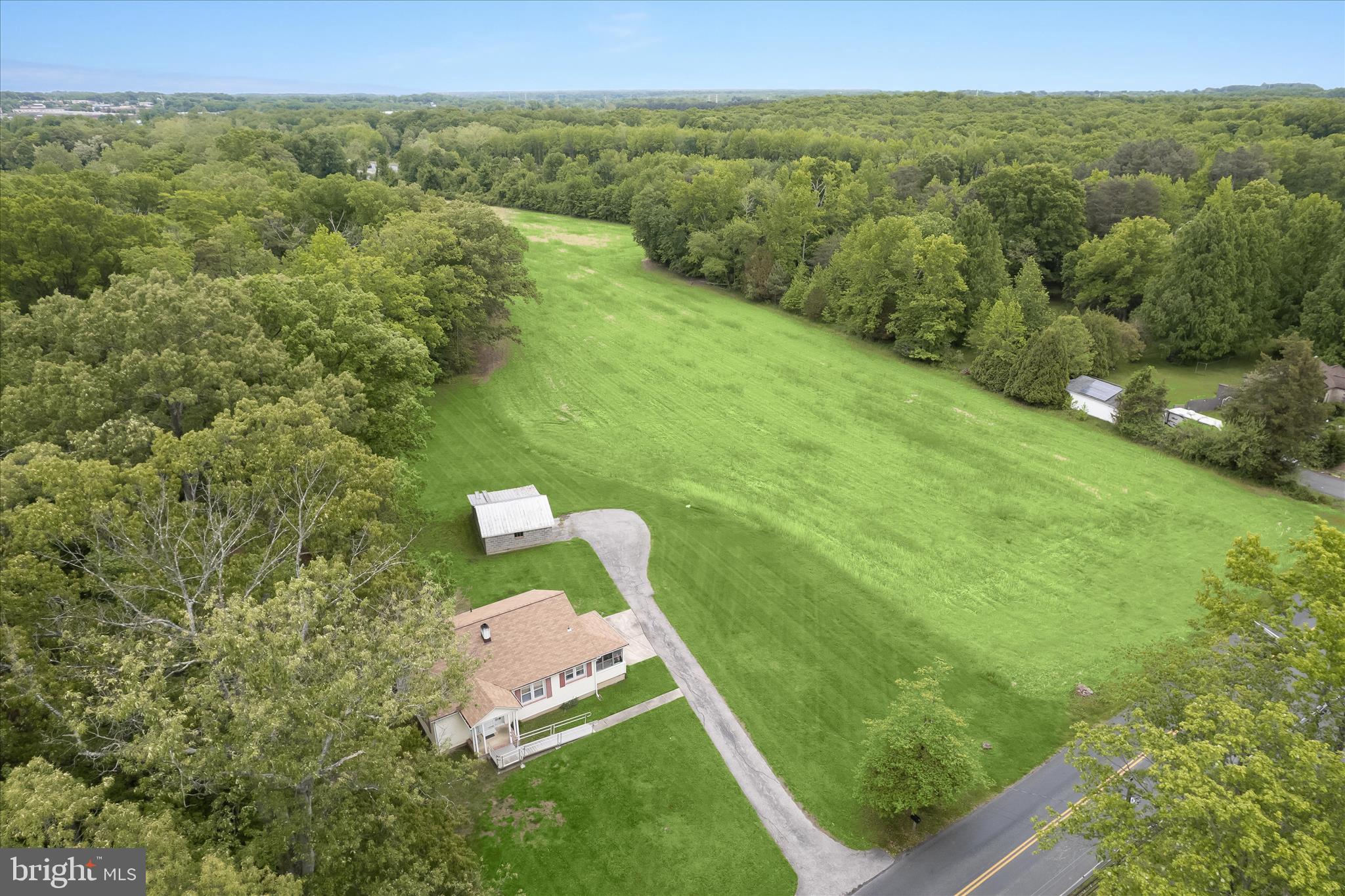 3703 Clayton Road Joppa, MD 21085 - Photo 6 of 31 a view of a lush green forest with trees in the background
