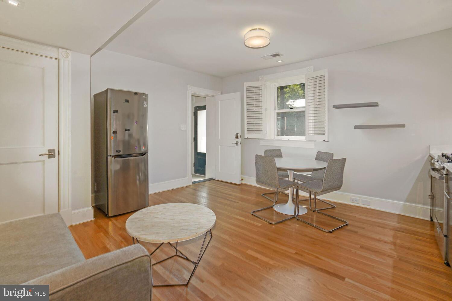 3348 Prospect Street Northwest, Unit 1 Washington, DC 20007 - Photo 4 of 16 a living room with furniture and a table
