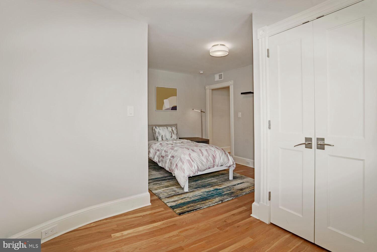 3348 Prospect Street Northwest, Unit 1 Washington, DC 20007 - Photo 6 of 16 a spacious bedroom with a bed and a wooden floor