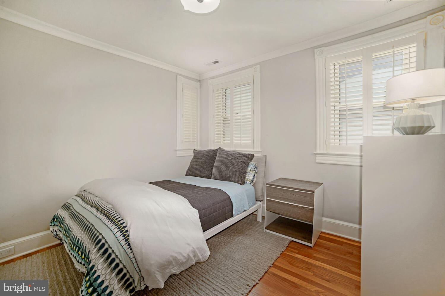 3348 Prospect Street Northwest, Unit 1 Washington, DC 20007 - Photo 10 of 16 a bedroom with a bed and wooden floor