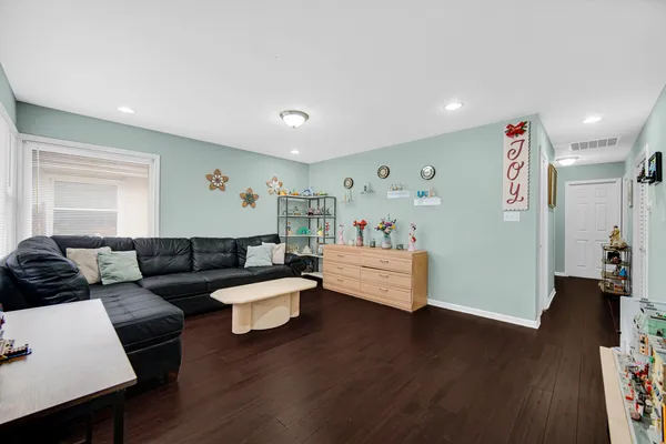 a living room with furniture and wooden floor