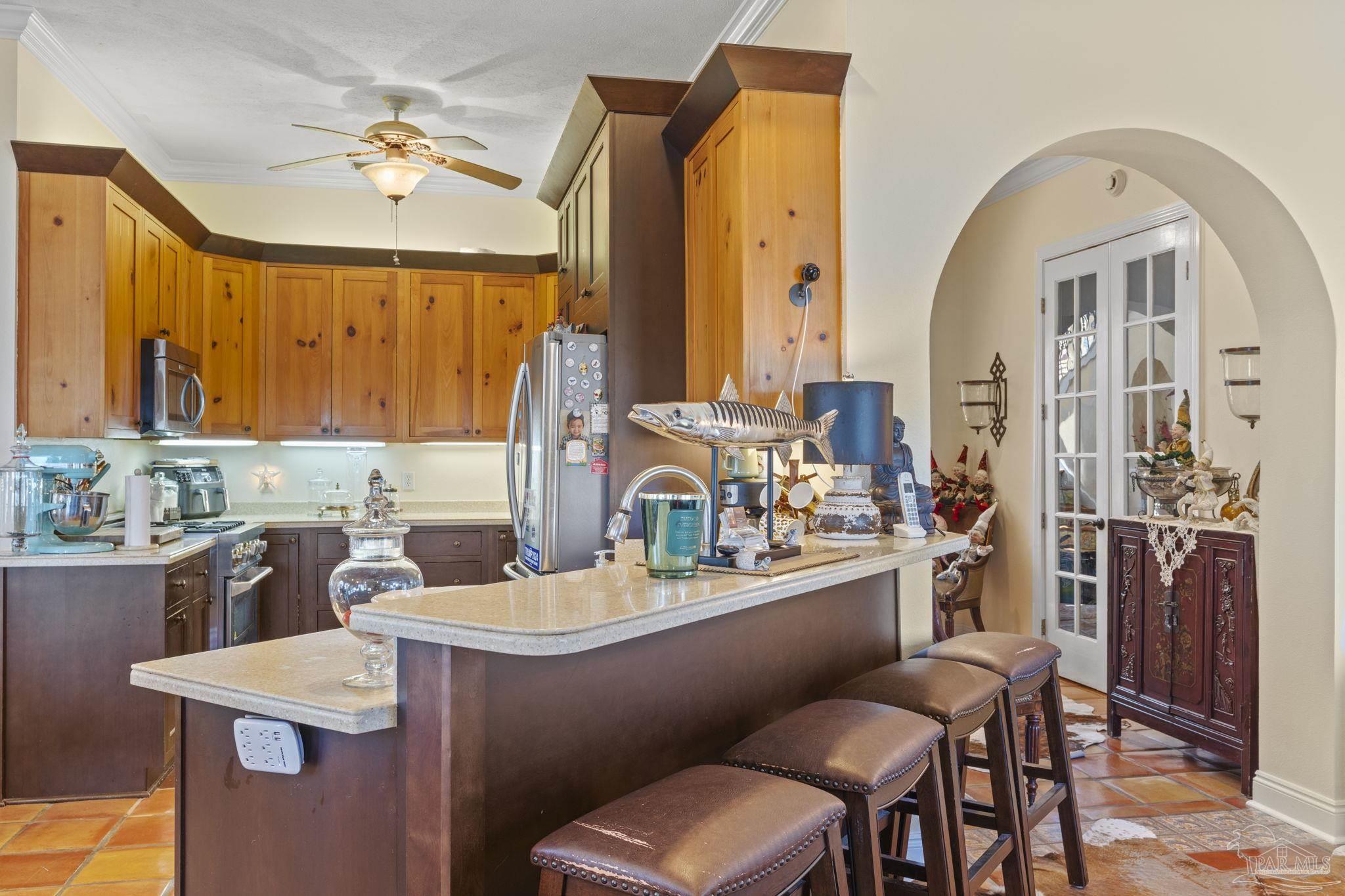 5460 North Shore Road Pensacola, FL 32507 - Photo 11 of 49 a kitchen with a table chairs sink and cabinets