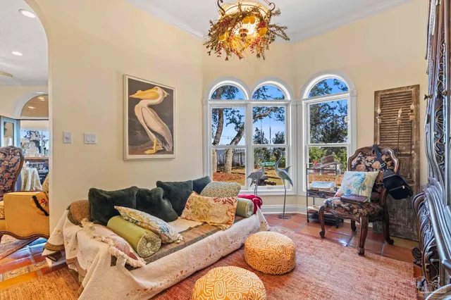 a living room with patio furniture and a wooden floor