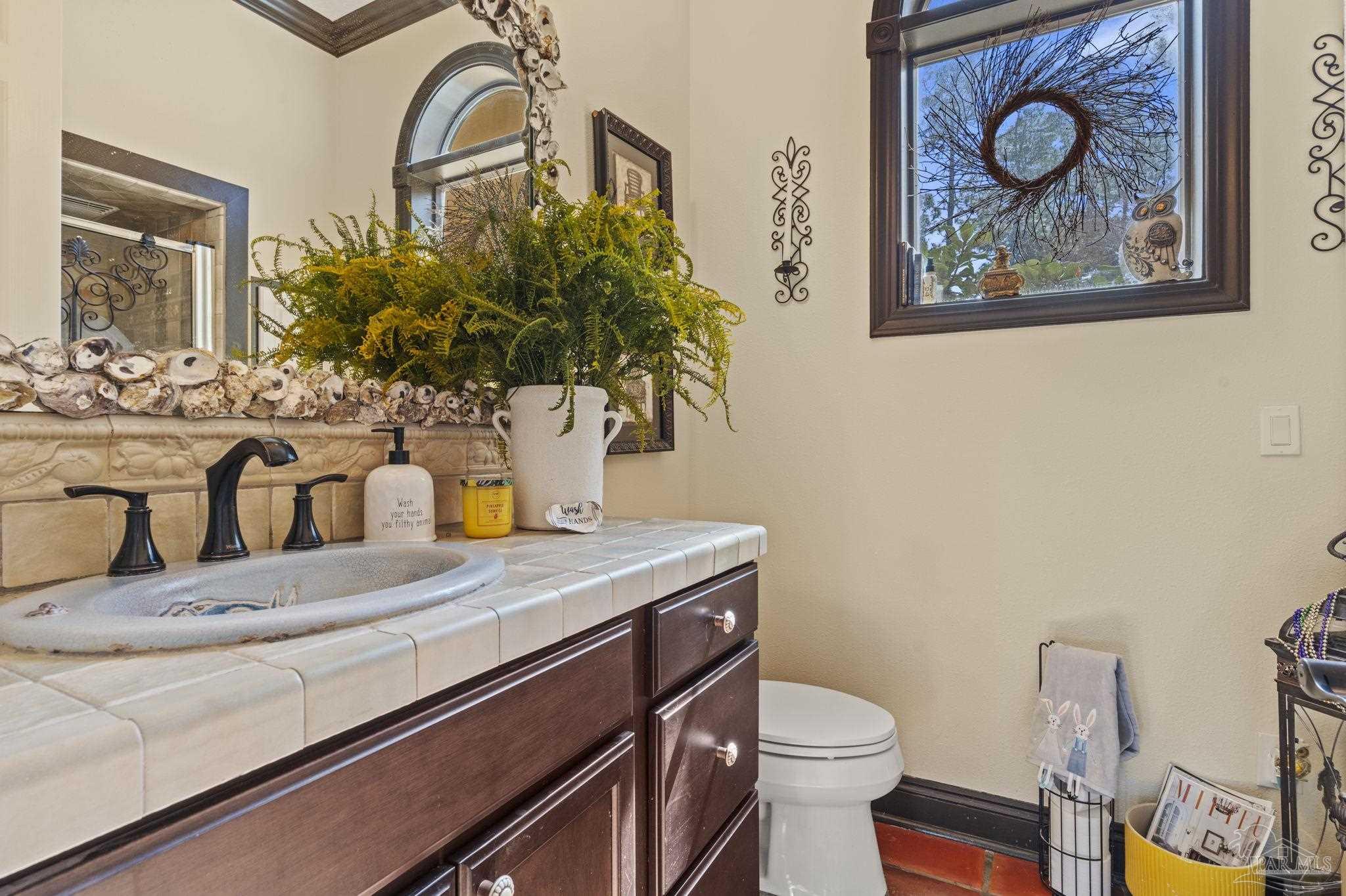 5460 North Shore Road Pensacola, FL 32507 - Photo 18 of 49 a bath room with a toilet and a sink