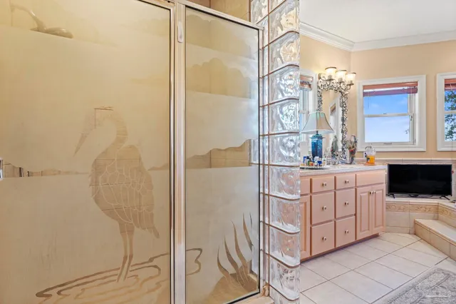 a bathroom with a double vanity sink mirror and shower