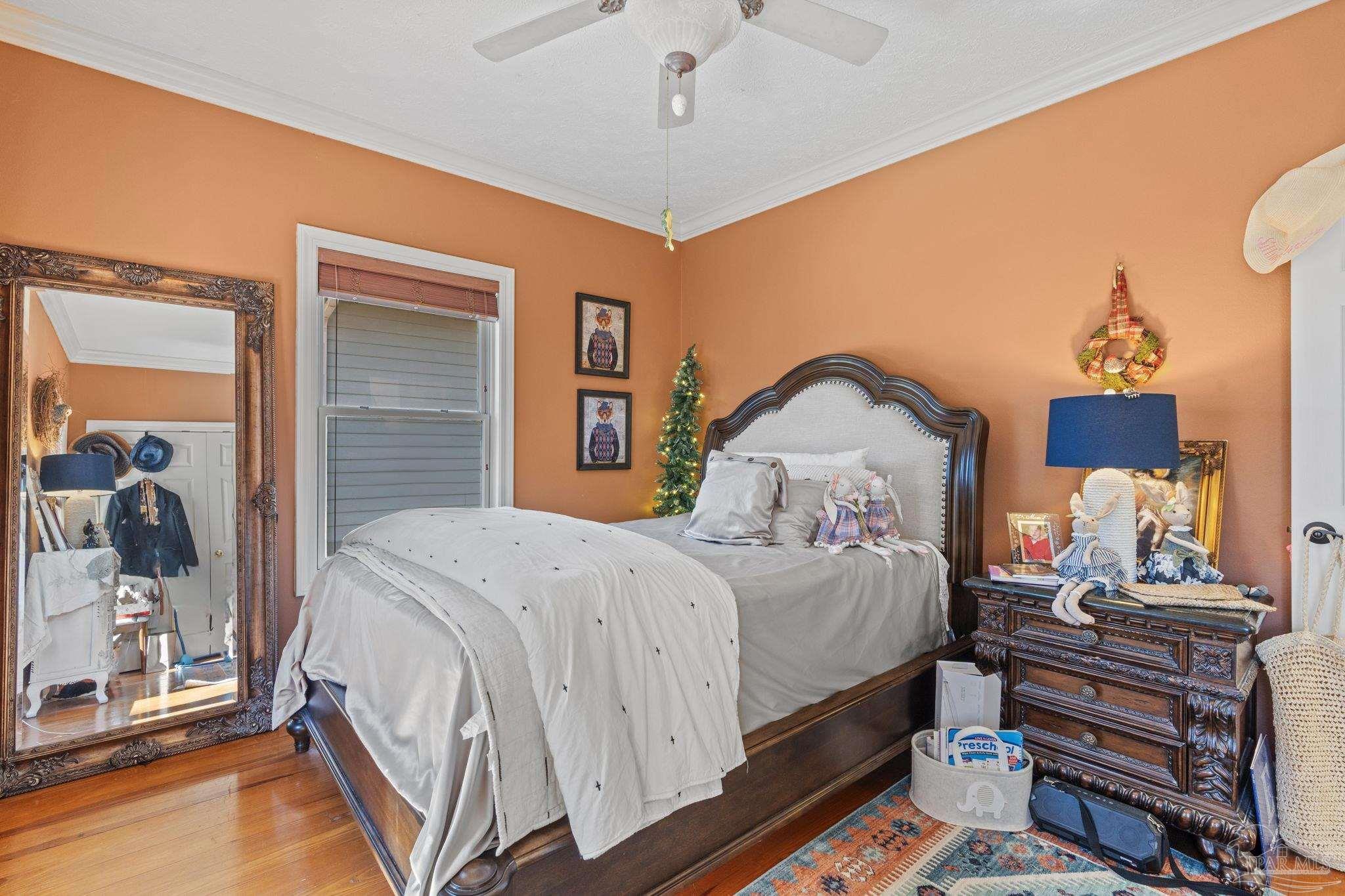 5460 North Shore Road Pensacola, FL 32507 - Photo 28 of 49 a bedroom with a bed and a chandelier