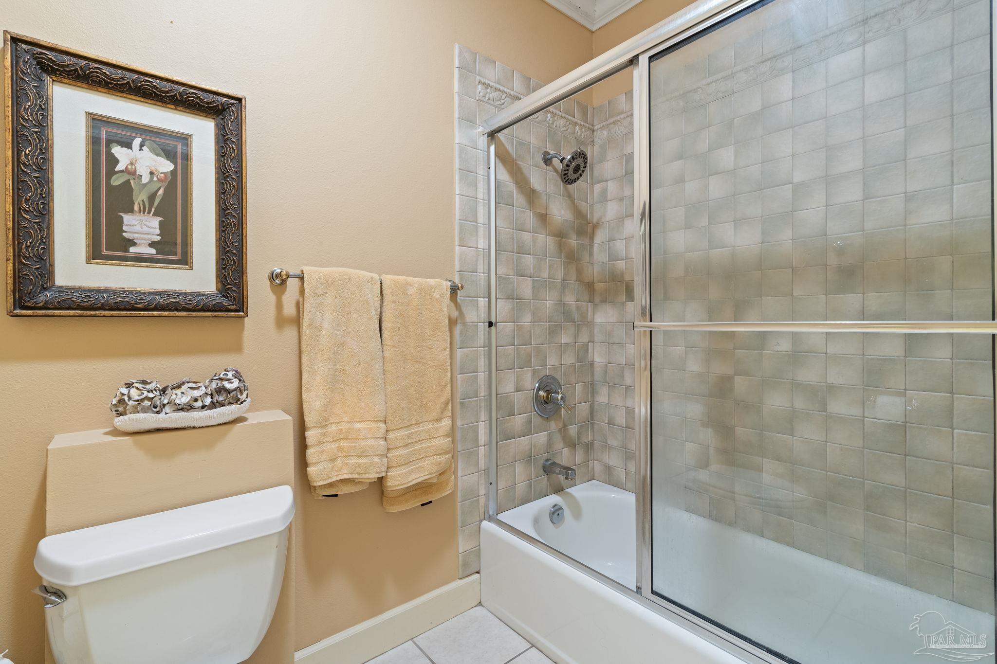 5460 North Shore Road Pensacola, FL 32507 - Photo 30 of 49 a bathroom with a shower a toilet and a bathtub