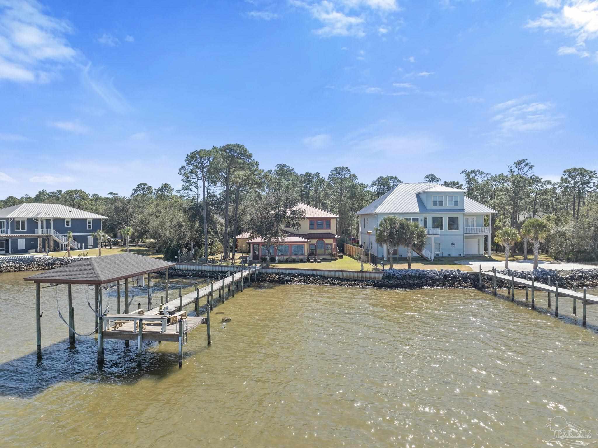 5460 North Shore Road Pensacola, FL 32507 - Photo 35 of 49 a view of a swimming pool with a table and chairs