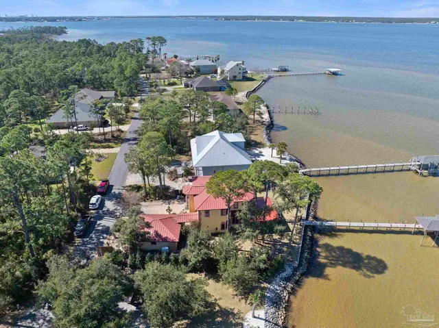 an aerial view of a houses with a lake view