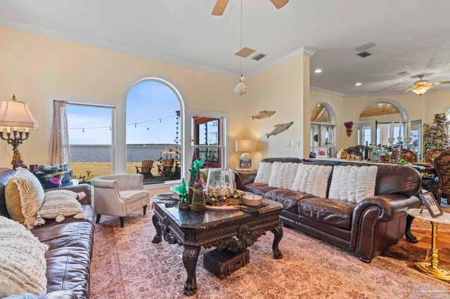a living room with lots of furniture and a large window