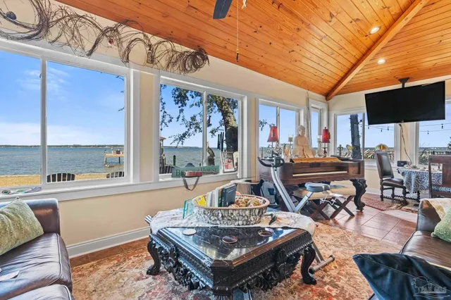 a living room with furniture a flat screen tv and a table