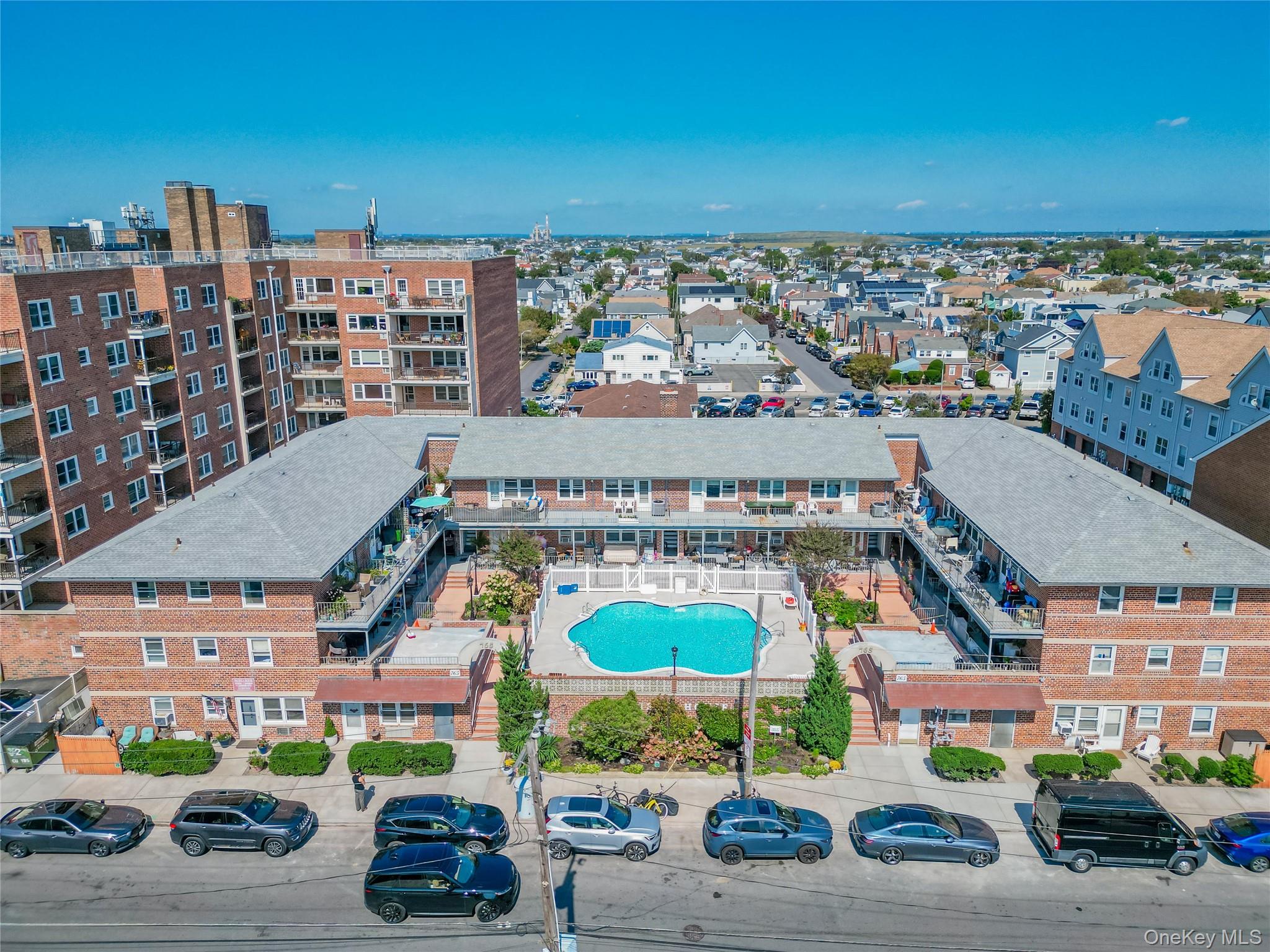 765 Shore Road, Unit 1M Long Beach, NY 11561 - Photo 1 of 12 Drone / aerial view of a pool