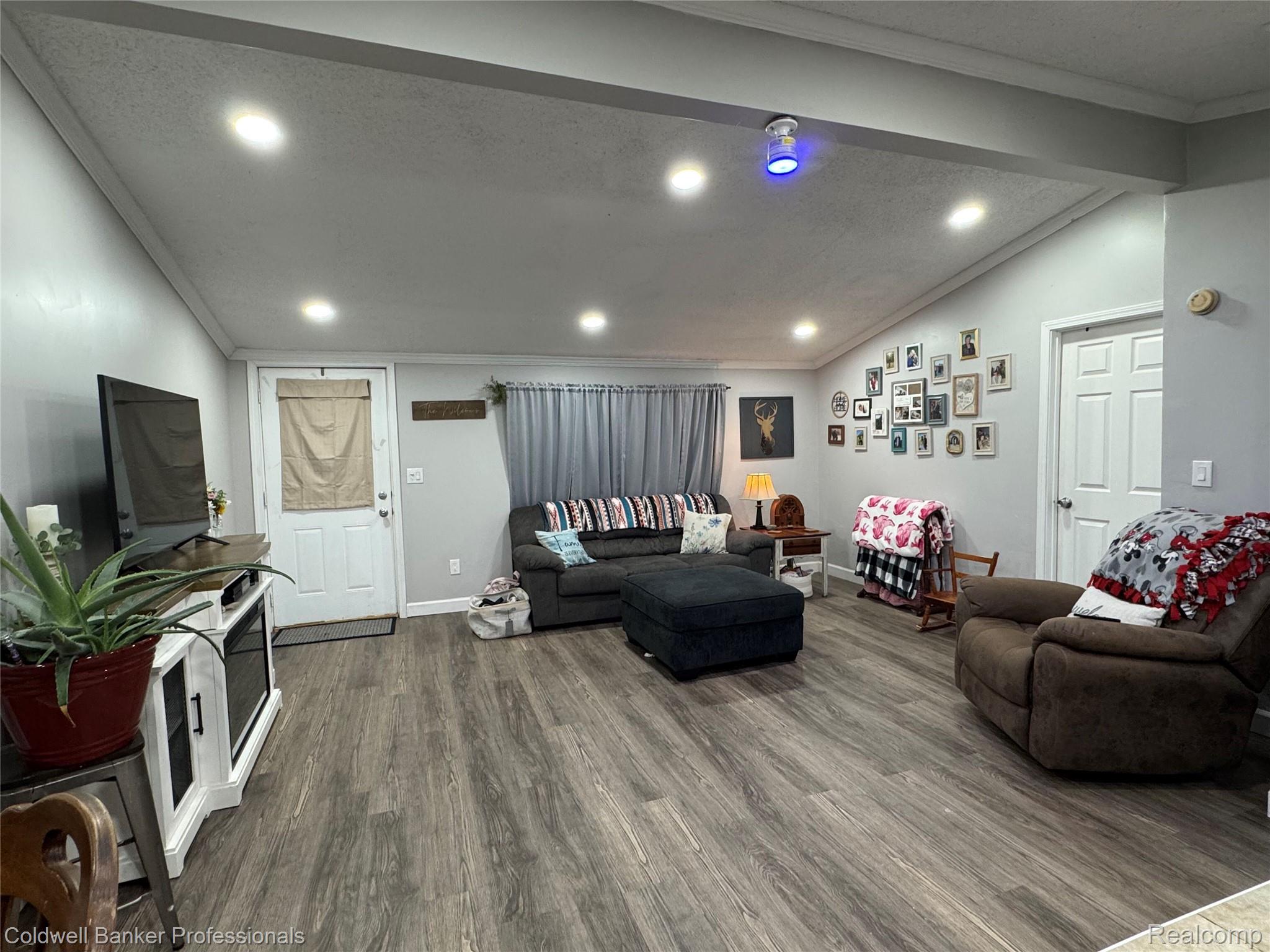 5323 English Road Clifford, MI 48727 - Photo 23 of 46 Vaulted ceiling with recessed lighting, wood-finish flooring, white paneled interior door, and light gray wall paint