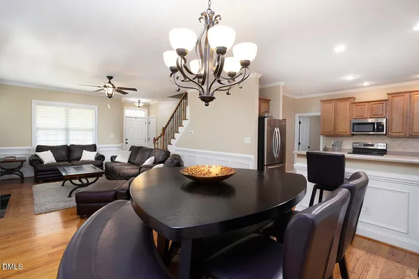 a view of a dining room with furniture and a chandelier