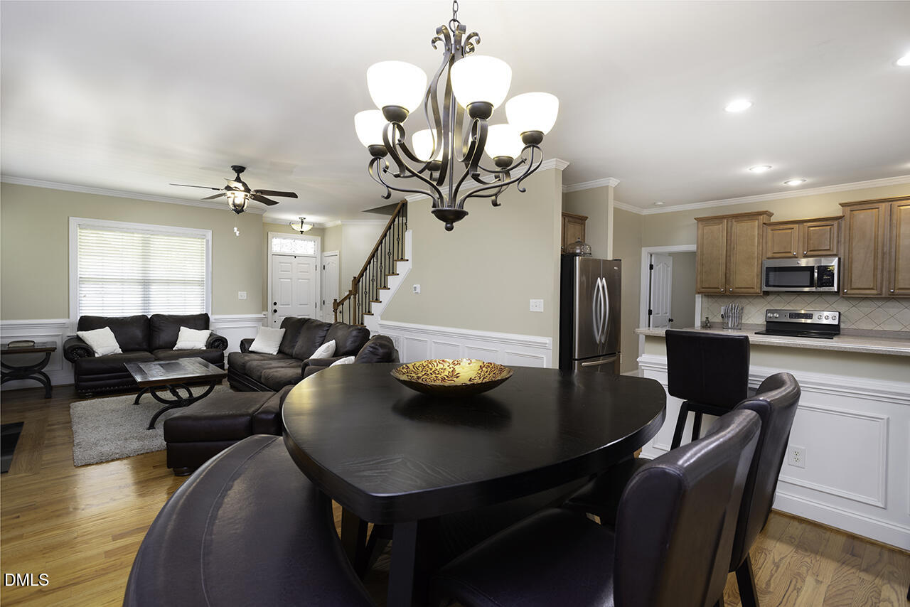 97 Bounty Circle Angier, NC 27501 - Photo 11 of 43 a view of a dining room with furniture and a chandelier