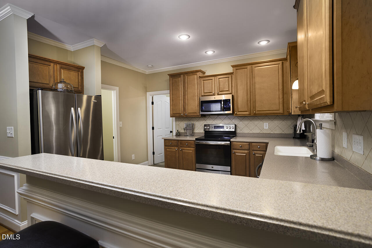 97 Bounty Circle Angier, NC 27501 - Photo 15 of 43 a kitchen with stainless steel appliances a refrigerator sink and microwave