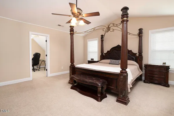 a bed room with a bed and a chandelier