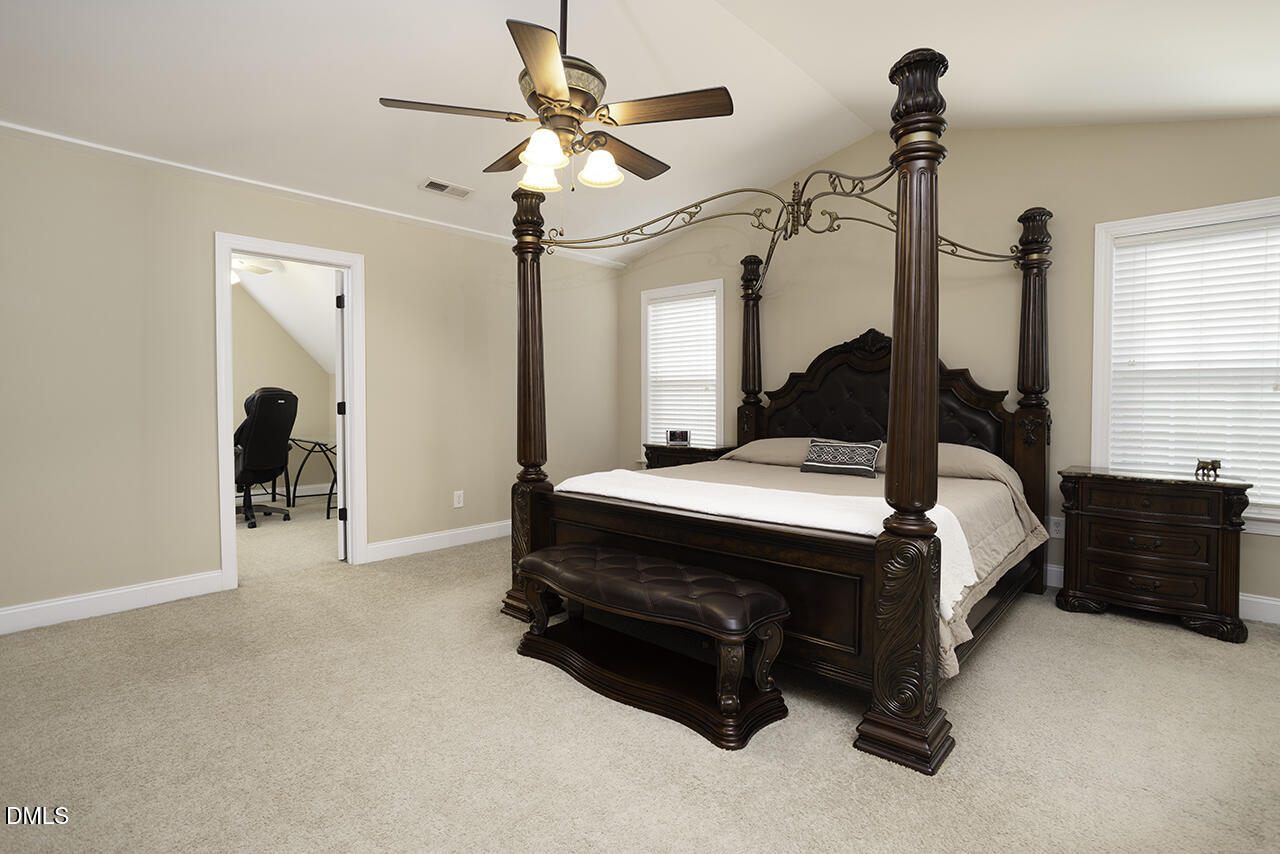 97 Bounty Circle Angier, NC 27501 - Photo 18 of 43 a bed room with a bed and a chandelier