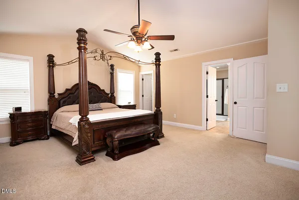 a bed room with a bed and a chandelier