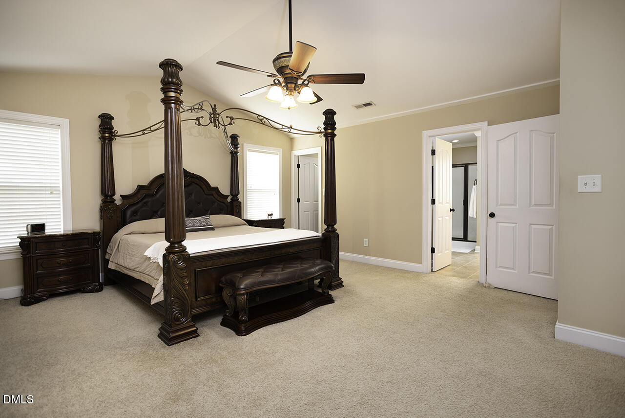 97 Bounty Circle Angier, NC 27501 - Photo 19 of 43 a bed room with a bed and a chandelier