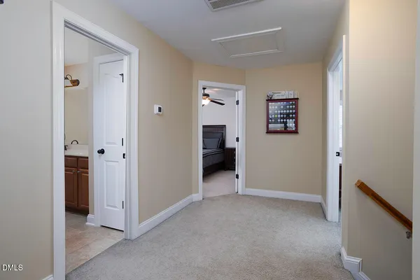 a view of an empty room with closet and a window