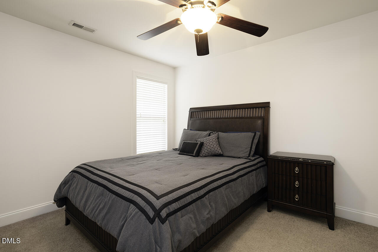 97 Bounty Circle Angier, NC 27501 - Photo 27 of 43 a bedroom with a bed and window