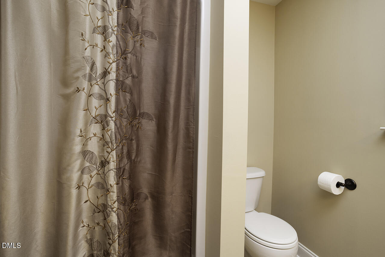 97 Bounty Circle Angier, NC 27501 - Photo 29 of 43 a white toilet sitting next to a shower curtain