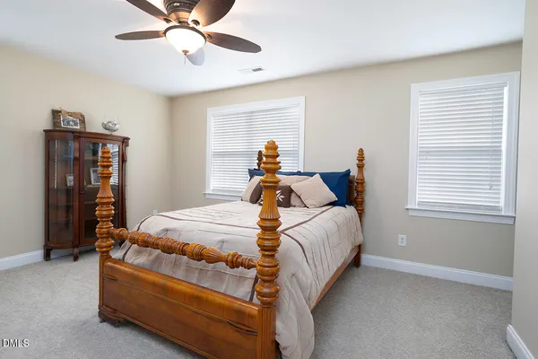 a bed room with a bed and a chandelier