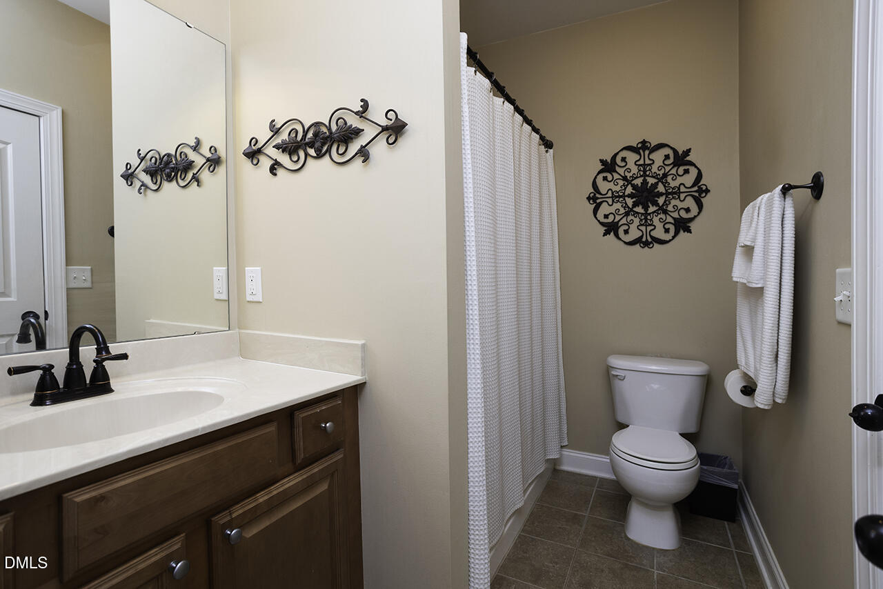 97 Bounty Circle Angier, NC 27501 - Photo 31 of 43 a bathroom with a toilet sink and mirror