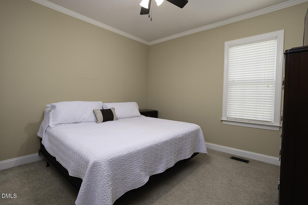 97 Bounty Circle Angier, NC 27501 - Photo 32 of 43 a bed sitting in a bedroom next to a window