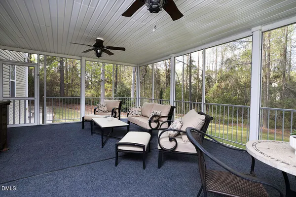 a living room with furniture and a floor to ceiling window