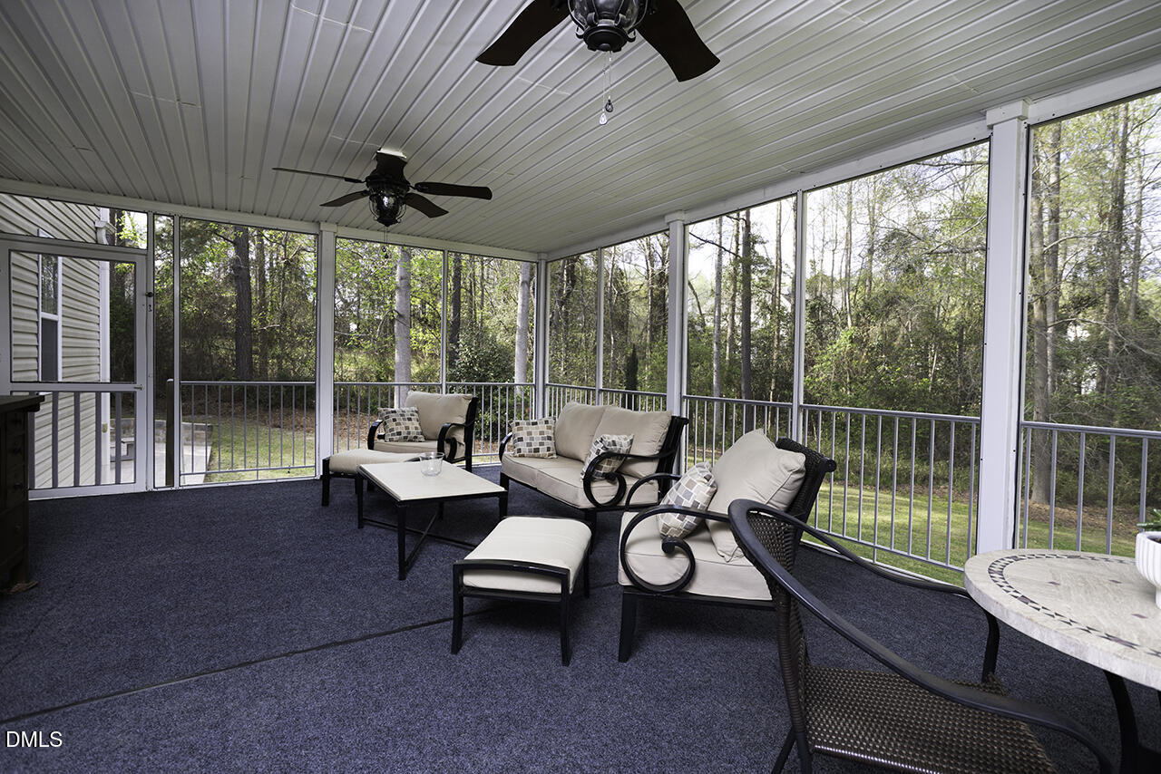 97 Bounty Circle Angier, NC 27501 - Photo 35 of 43 a living room with furniture and a floor to ceiling window