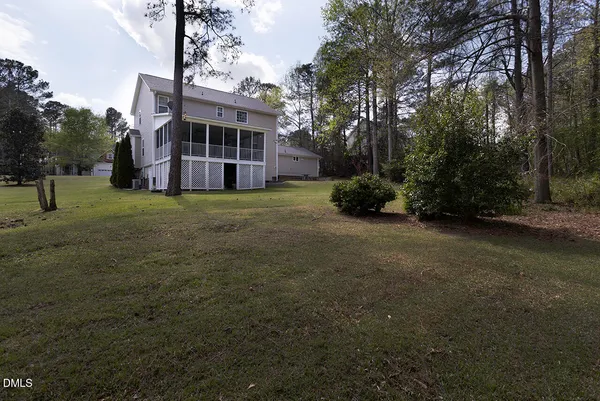 a view of house with yard and entertaining space