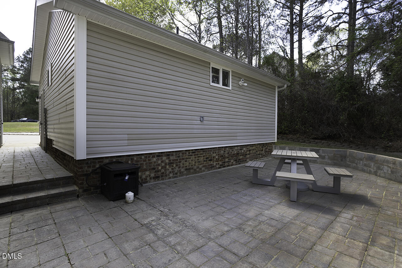 97 Bounty Circle Angier, NC 27501 - Photo 41 of 43 a backyard of a house with barbeque oven table and chairs