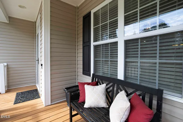a view of balcony with wooden floor and windows