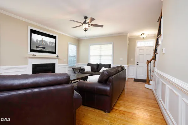 a living room with furniture a flat screen tv and a fireplace