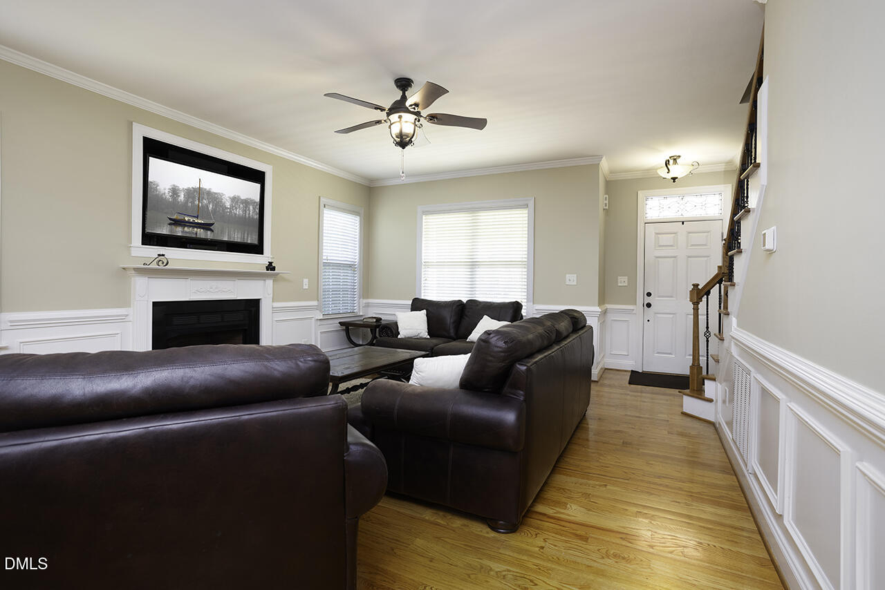 97 Bounty Circle Angier, NC 27501 - Photo 9 of 43 a living room with furniture a flat screen tv and a fireplace
