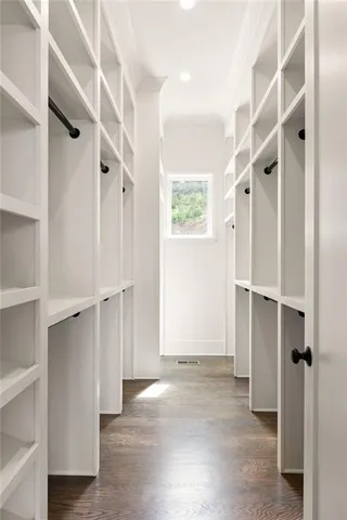 a view of walk in closet with empty racks