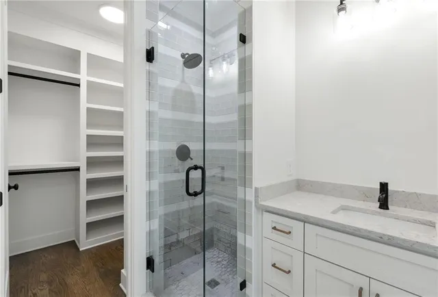 a bathroom with a shower and a sink