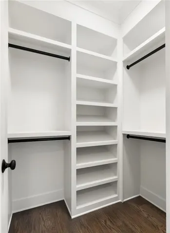 a view of walk in closet with empty racks