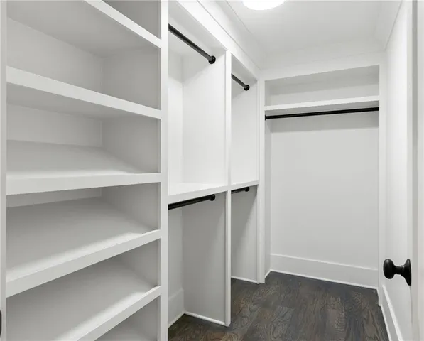 a view of walk in closet with empty racks