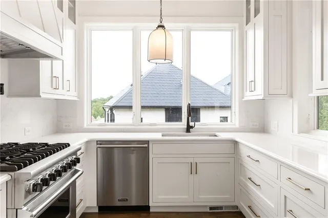 a kitchen with white cabinets and white appliances