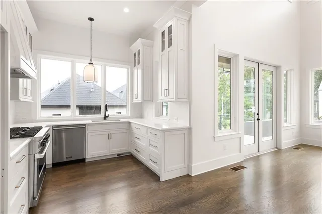 a kitchen with a white stove top oven sink and window